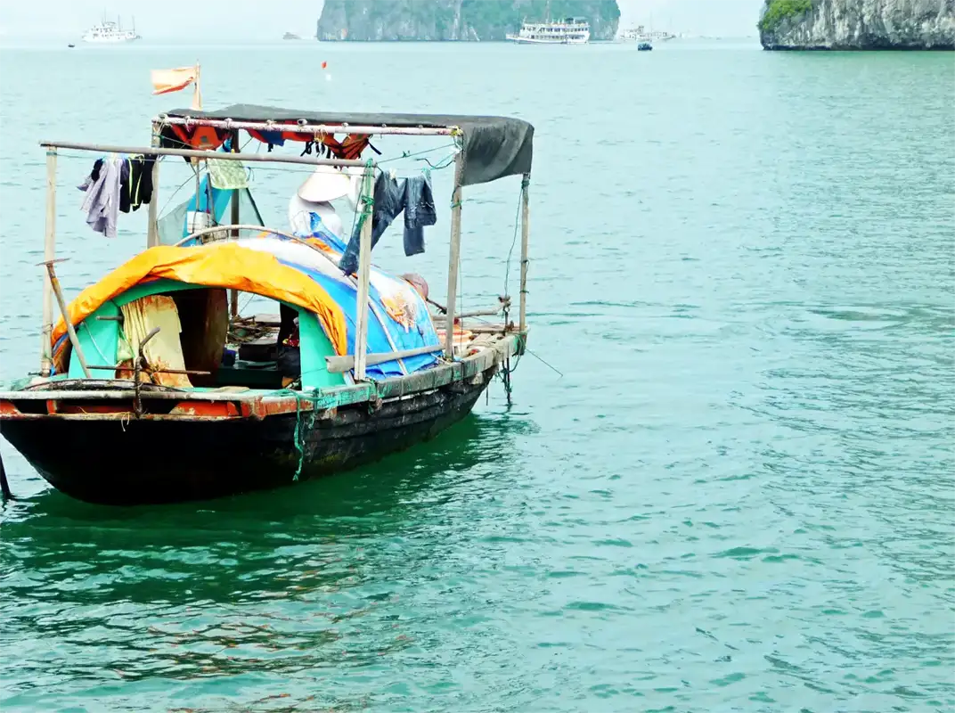 During the Halong Bay cruise, we passed many small fishing boats with people fishing and living on board.