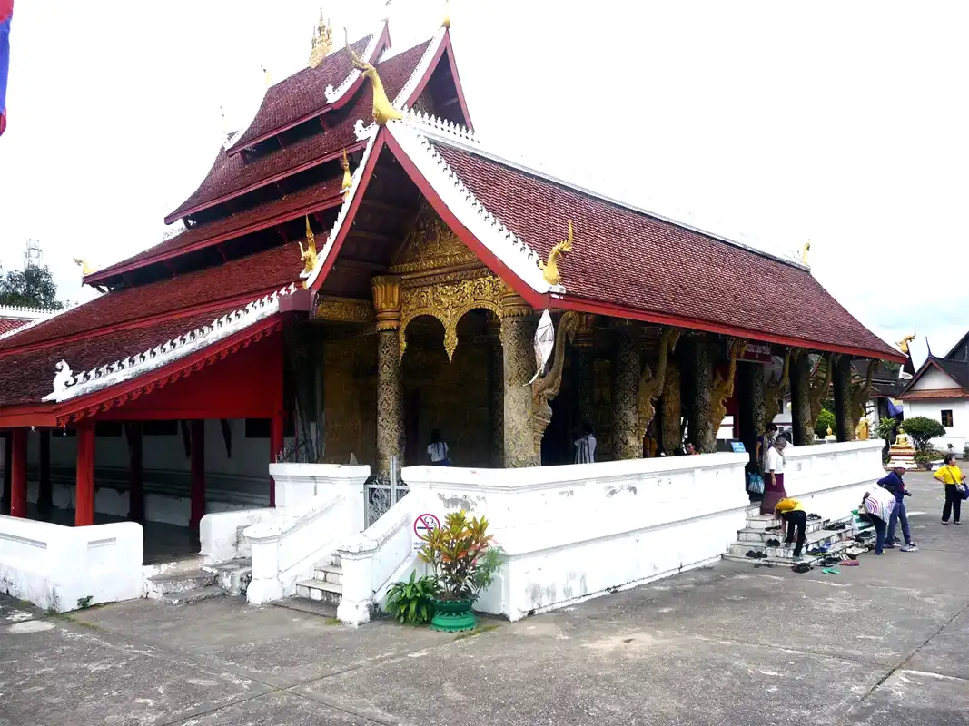 Wat Aham is a simple temple, but its interior is bright and colourful. Later, the temple was rebuilt many times. People believed that the spirits had moved into the two large banyan trees in front of it.