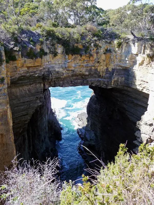 Nearby are the Tasman Arch, the Blowhole, and Devil's Kitchen.