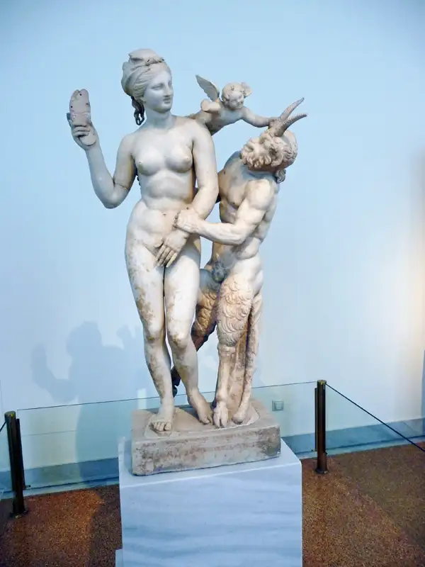 They made romantic statues even before 100 BC. This stunning marble statue shows Aphrodite, Pan, and Eros. Then we went again to the ancient Agora