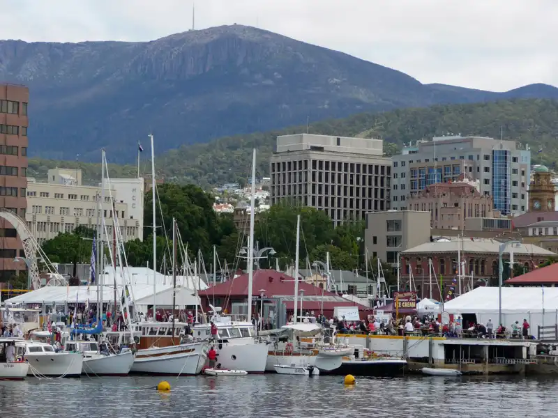 Hobart Waterfront with boats in the harbour and kunanyi / Mount Wellington rising in the background.