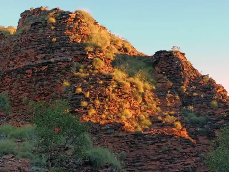 Late-afternoon walk through Mirima National Park near Kununurra, with glowing sandstone cliffs lit by warm evening light.