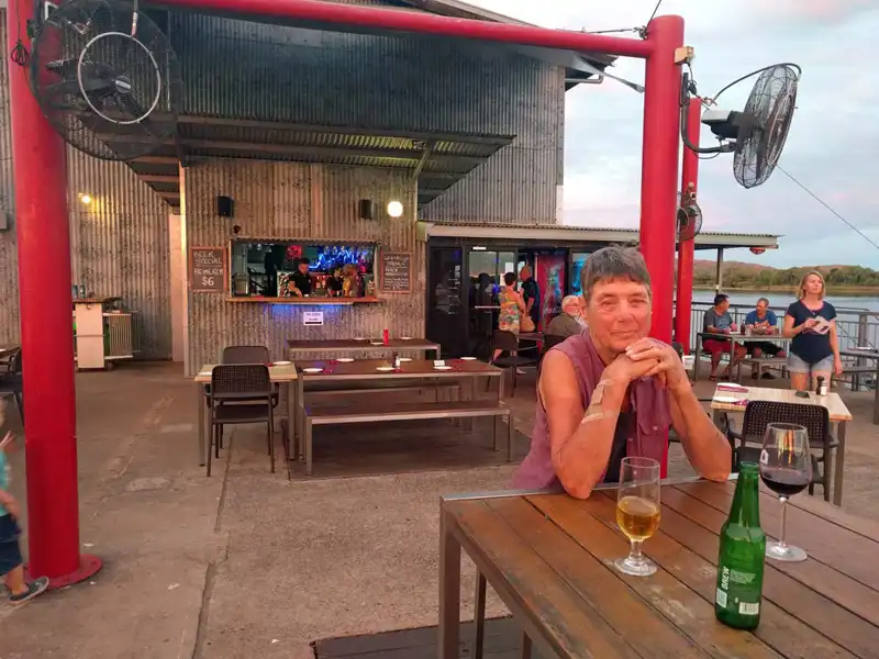 Sunset at The Pump House on the Ord River near Kununurra, with outdoor seating overlooking calm water and surrounding Kimberley landscape.
