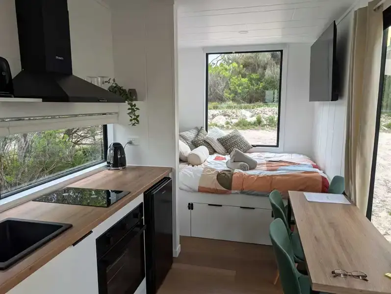 Kitchen, workspace and bed Inside container accommodation Penneshaw Kangaroo Island