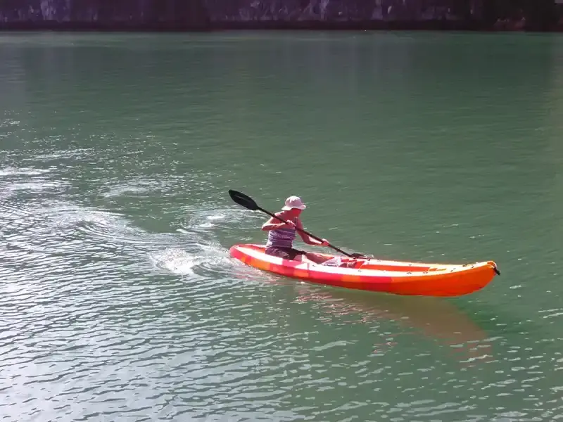 Kayaking through the towering limestone karsts of Ha Long Bay in Vietnam.