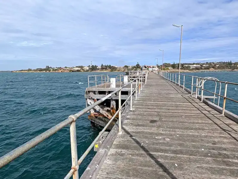 the long Kingscote Jetty water on both sides and Kingscote in the background.