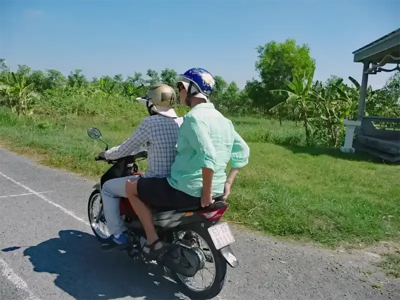 Riding a motorbike through Vietnam’s lush Mekong Delta,