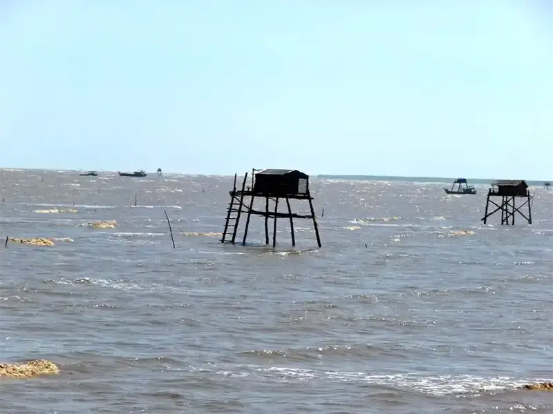 Tan Thanh Beach with stilt houses and colorful fishing boats,