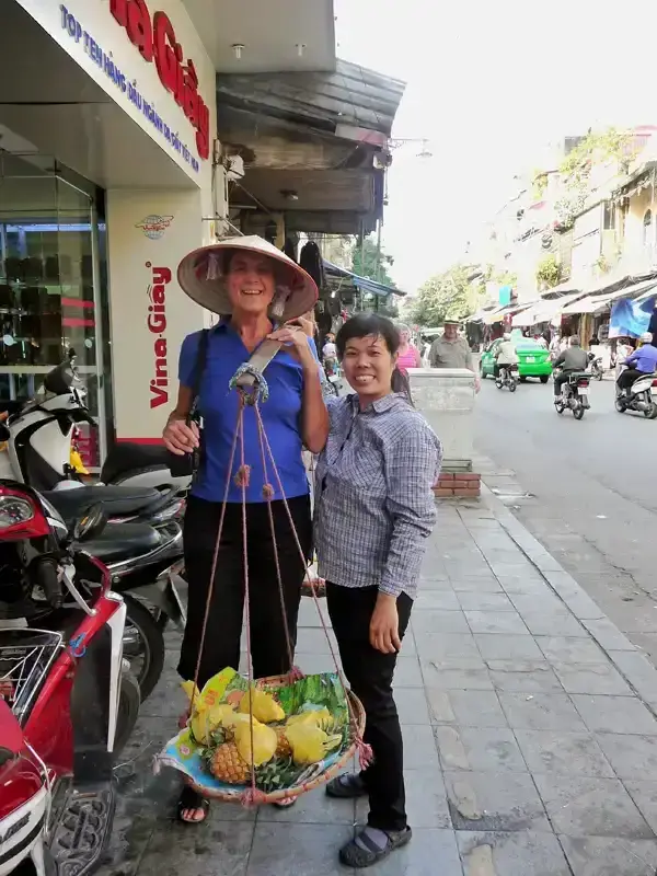 Vietnamese women, street fruit vendor, Hanoi,Vietnam