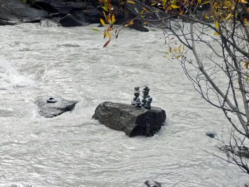 Traditional Inukshuk stone figure on a hiking trail in British Columbia, Canada, used as a landmark for travellers.