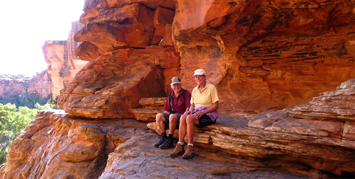 Two independent seniors enjoying the view after hiking the Kings Canyon Rim Walk, Red Centre, Australia.
