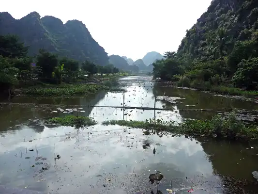 Limestone karst landscape with rivers and rice fields in Ninh Binh, Vietnam.
