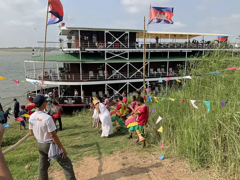 group of local villagers dressed in elaborate traditional costumes greated us while embarking at a small village, Cambodia